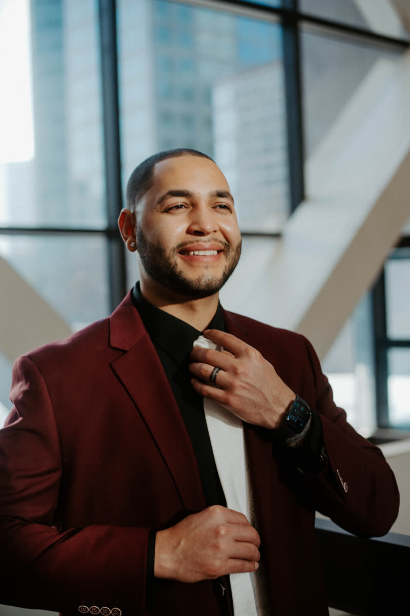 Christian King Atlas, smiling, in a maroon blazer